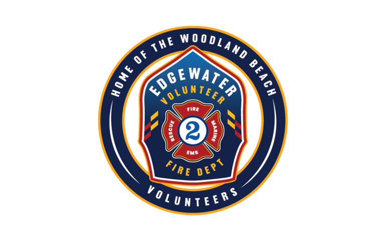 Circular logo for Edgewater Volunteer Fire Dept. Features a firefighter helmet with "Rescue", "EMS", and "Fire" written on it. Text around the logo reads "Home of the Woodland Beach Volunteers.