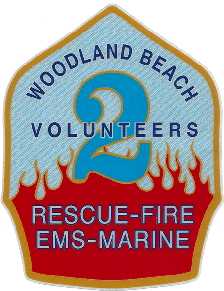 Patch with a large blue number 2 surrounded by orange flames. Text reads "Woodland Beach Volunteers, Rescue-Fire EMS-Marine." The patch is shield-shaped with a red and gold border.